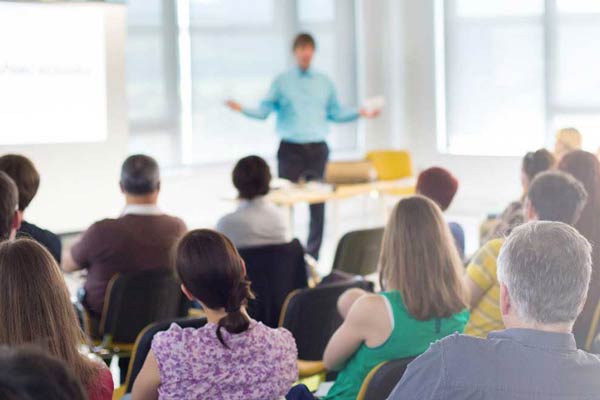 person speaking to a large audience