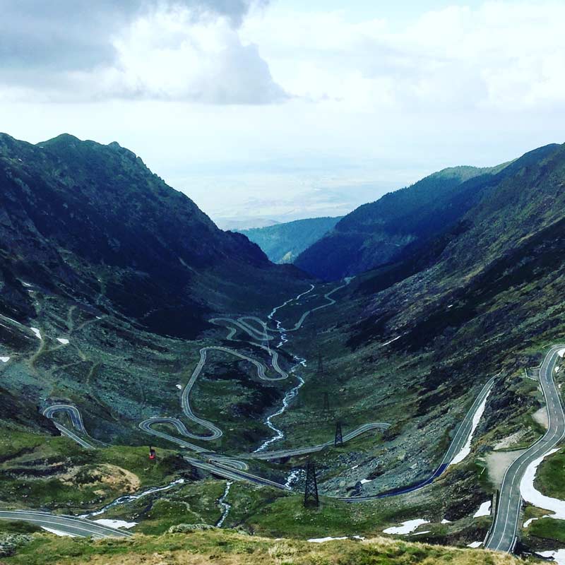 an extremely winding road in a valley