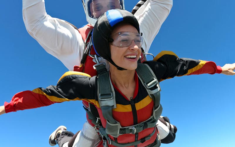 people jumping out of a plane, parachuting, representing freedom